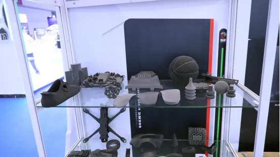 Zongheng3D Unveils Three Industrial 3D Printers at Formnext Shenzhen 2026 Showcase cabinet filled with diverse SLS 3D printed functional prototypes and end-use components