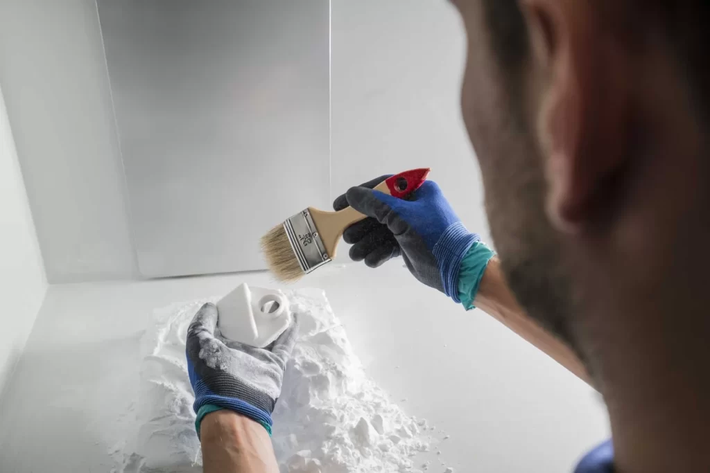 How Does SLS 3D Printing Work? unpacking of spare parts from powder bed selective laser sintering