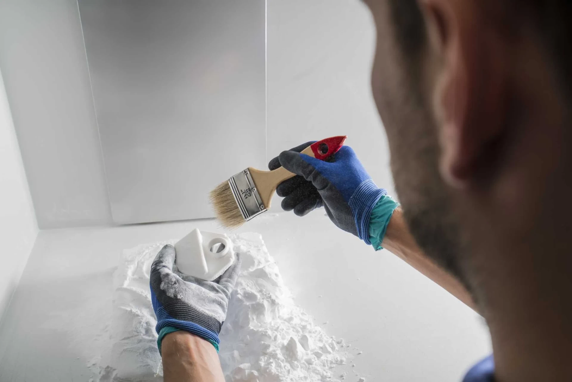 How Does SLS 3D Printing Work? unpacking of spare parts from powder bed selective laser sintering